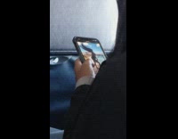 Woman chooses perfect hair flip video on her phone