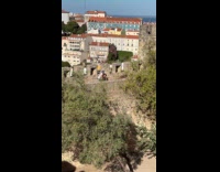 Woman exercises for video at castle top
