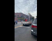 Man in mask driving car with halloween decorations