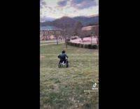 guys rides wheelchair down small hill 
