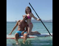 Couple posing on paddle board fall in water