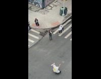 Guy with ears lays in street 