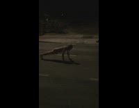 Guy does push ups naked in the middle of street as cars drive by