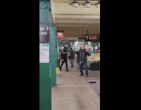 Guy doing a warmup exercise routine at subway train station 
