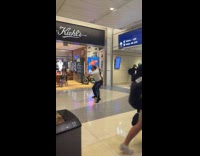 Man pilot outfit dances inside airport hallway