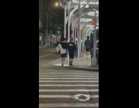 Ghost mascot giant black wait along the street at night 