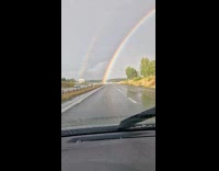 Double rainbow seen on the rainy highway