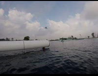 Guy wakeboarding tries to do trick but slams body into white pipe and falls into water