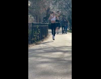 Woman jogs and films herself at park