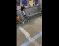 Woman dancing and mouthing lyrics to song at station