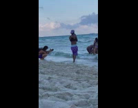 Four women pose with their butt beach