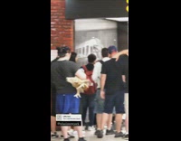 Guy in line holds deer head 