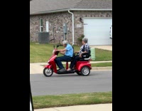 Collab VIBES - Elderly couple on red mobility scooter 