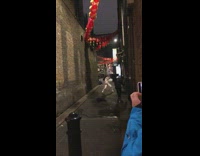 Girl in white outfit dancing under red lamps