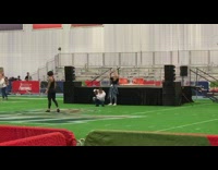 Woman jumps for picture on indoor soccer field