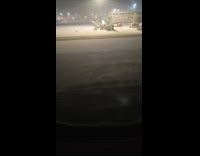 Wind blows snow effect airport runway night