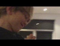 Kid blows into wood stick blowgun 