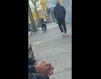 Guy tries to catch brown chicken sidewalk 