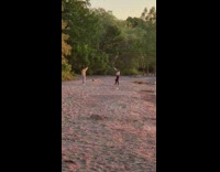 Girl holds sunset sun illusion beach sand 