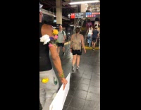 Collab WINY - Man black top tank flowers on body carry mirror subway