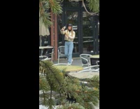 girl records herself ski lodge snowing