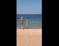 Woman beige dress run for beach video