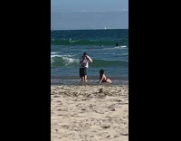 Girl bend over sand ice cream vendor