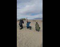 Man shirtless backflip pineapple three photographers sand