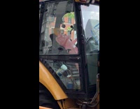 Human balloon sits inside bulldozer 