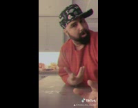 Man red shirt dances on kitchen island