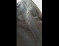 Guy finds small caterpillar crawling across bag