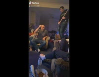 Guys hit bottle cap on head 