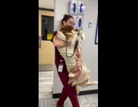 Vet holding dog pretending to swim