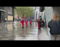 Group women red clothes dance wet street part 1