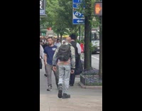 Man walk street cat on shoulder backpack