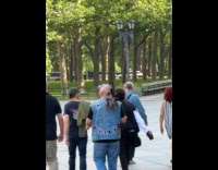 Man carries gun with some hunted rodents
