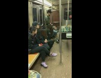 Guys play a game of foosball on subway train