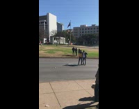 Two guys arm on shoulders Dealey plaza