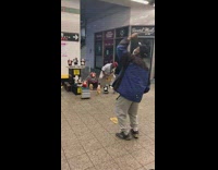 Saxophone subway performer with his biggest fan