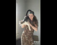 Leopard print dress girl poses with cat