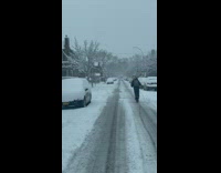 2 people ride scooter in the snow 
