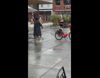 Girl white gloves dance outside red bike