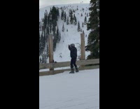 Man Dances Near Wooden Fence in Mountains