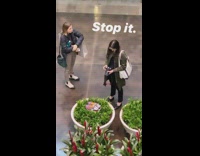 woman takes pics shoes in plant mall
