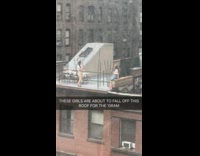 two girls roof building take pictures