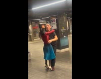Man dancing with female mannequin on subway station