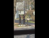 Two women black shirt dance mailbox street