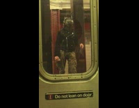 man with silver mandalorian mask waits for train