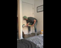 Guy struggles to open closed door hands full 