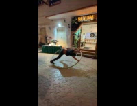 Man spins on giant hula hoop outside restaurant